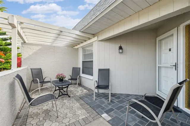 a dining room with furniture and a floor to ceiling window