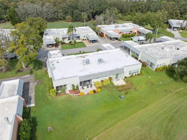 an aerial view of a house with a garden and swimming pool