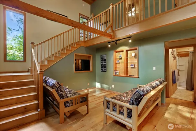 a living room with fireplace furniture and a large window