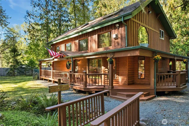 a view of a house with pool and sitting area