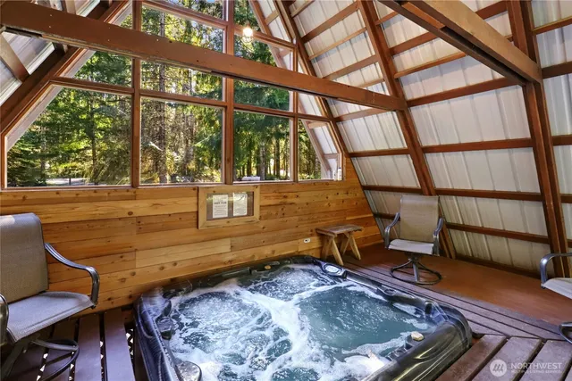 a backyard of a house with wooden floor and outdoor seating