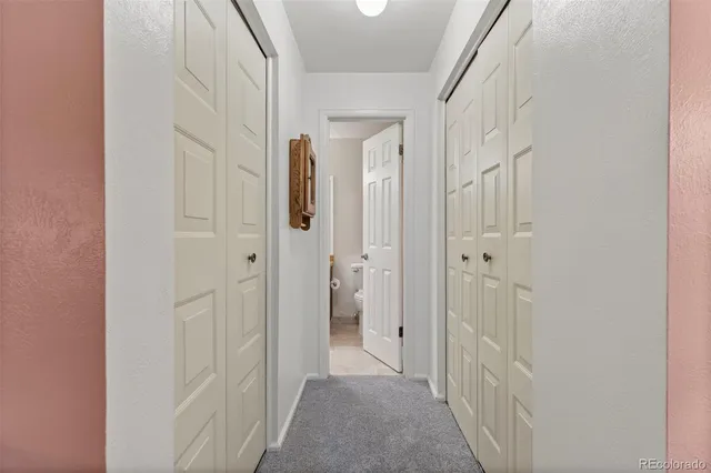 a bathroom with a granite countertop sink a toilet and mirror