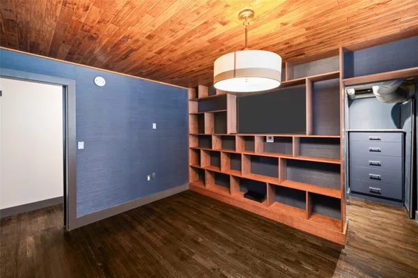 a bedroom with bed and a book shelf