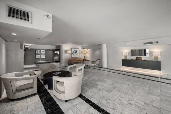a living room with furniture and view of kitchen