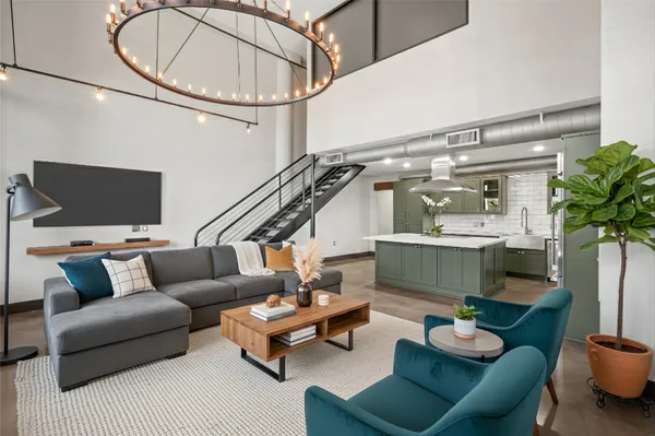 a living room with furniture and a chandelier