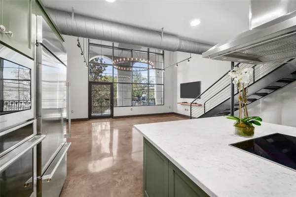 a view of kitchen and hall with wooden floor