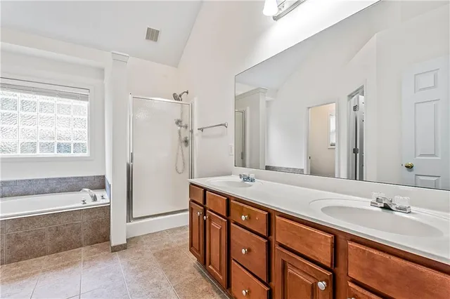a bathroom with a tub sink and mirror