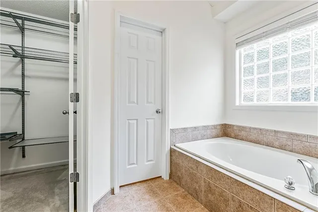 a spacious bathroom with a tub and a shower