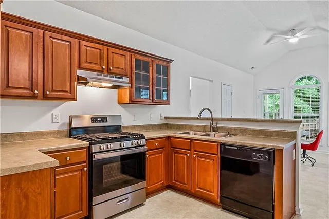 a kitchen with stainless steel appliances granite countertop a stove and a sink