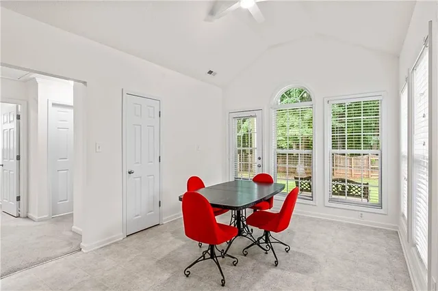 a living room with furniture and floor to ceiling windows