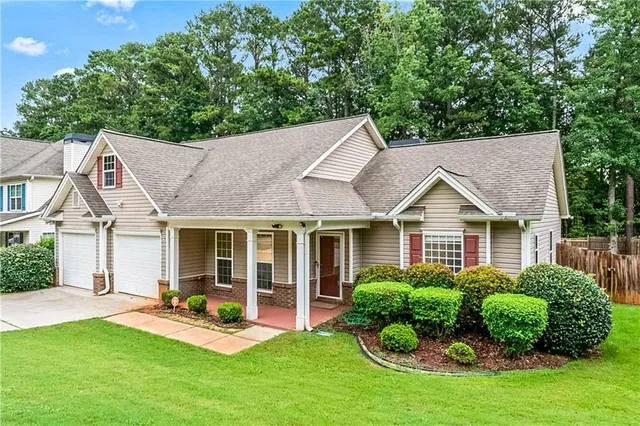 a view of a house with backyard sitting area and garden