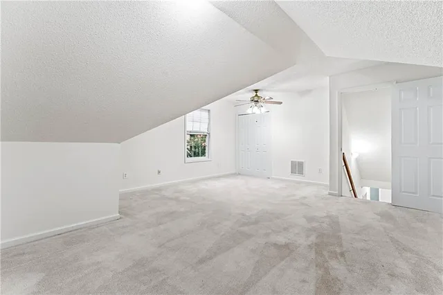 a view of a big room with closet and windows