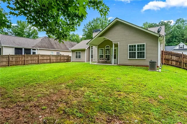 a view of a house with a yard and sitting area