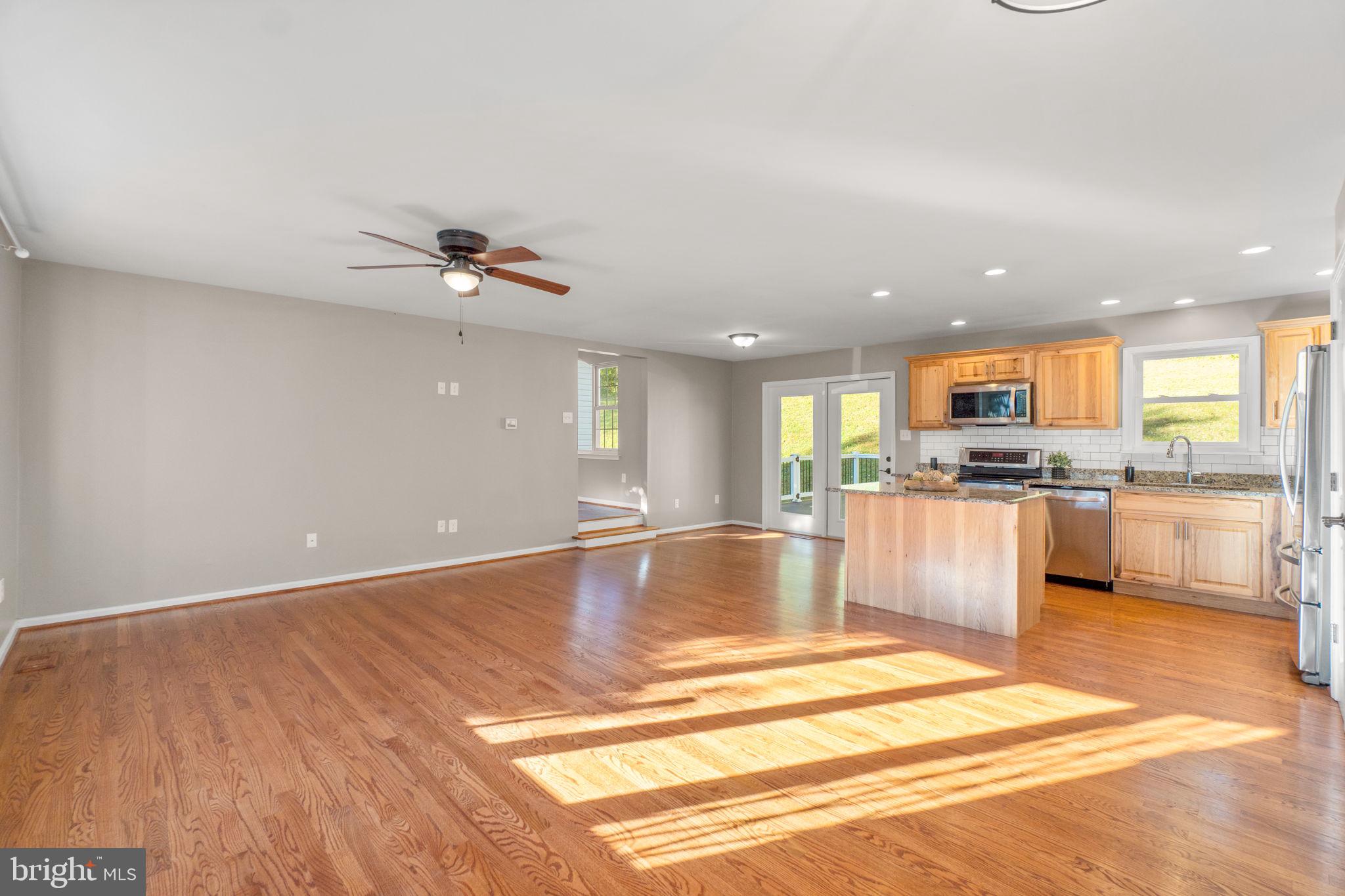 1414 Old New Windsor Road New Windsor, MD 21776 - Photo 3 of 10 a view of a kitchen with kitchen island a counter top space appliances and a ceiling fan