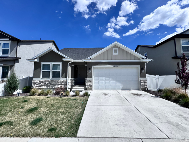 12339 Remy Road, Unit 422 Herriman, UT 84096 - Photo 2 of 36 View of front of house with a garage, concrete driveway, board and batten siding, stone siding, and stucco siding