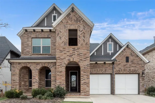 a front view of a house with yard