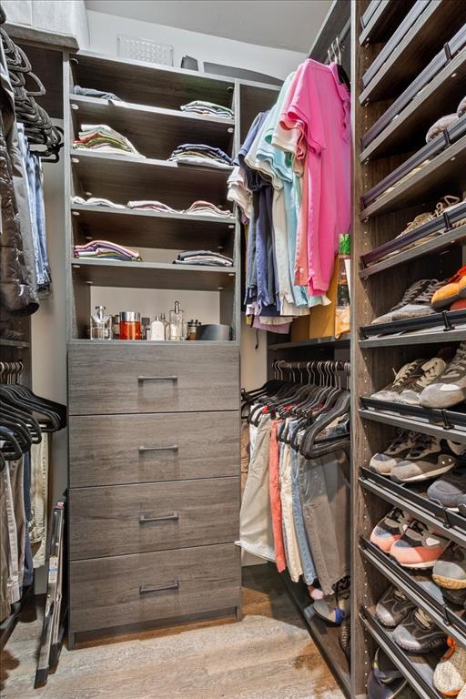 15988 Wortham Bend Road China Spring, TX 76633 - Photo 22 of 40 Custom closet system featuring built-in shelving, hanging rods, and a four-drawer dresser unit