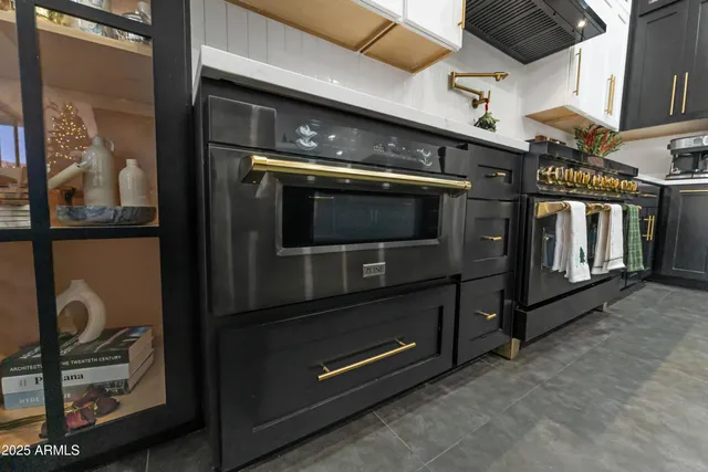 a living room with furniture a chandelier and a window