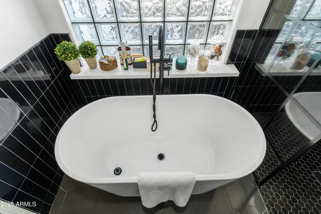 a spacious bedroom with a bed and a large mirror