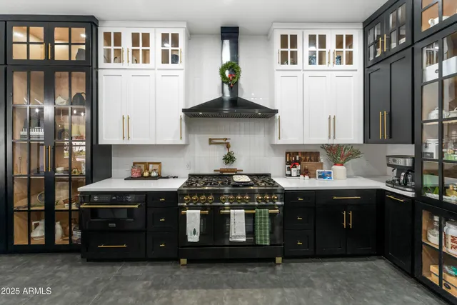 a kitchen with stainless steel appliances granite countertop a refrigerator and a stove top oven