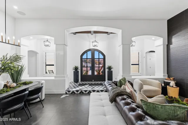 a living room with furniture and a chandelier