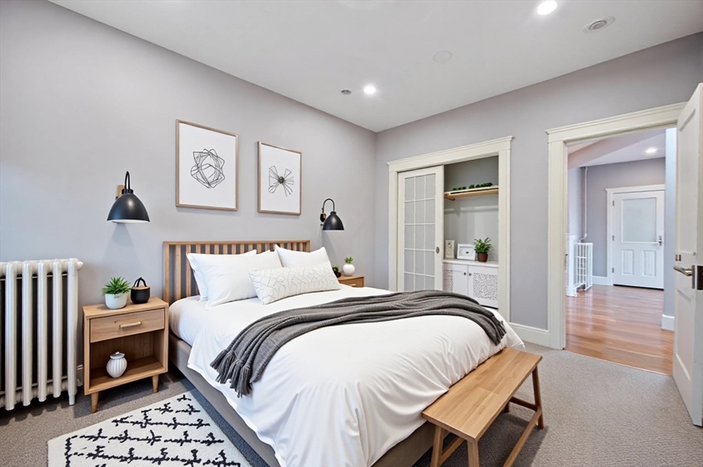 21 Sutherland Road, Unit 15 Boston, MA 02135 - Photo 6 of 13 a bedroom with a bed and a table