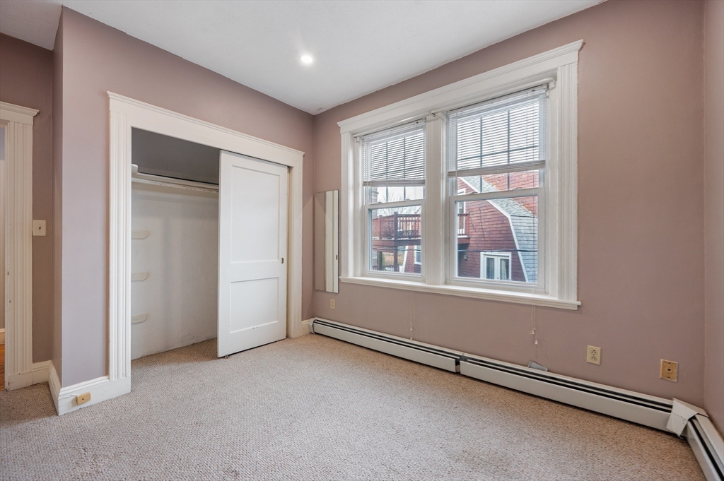 21 Sutherland Road, Unit 15 Boston, MA 02135 - Photo 10 of 13 an empty room with windows