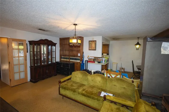 a living room with furniture fireplace and a table