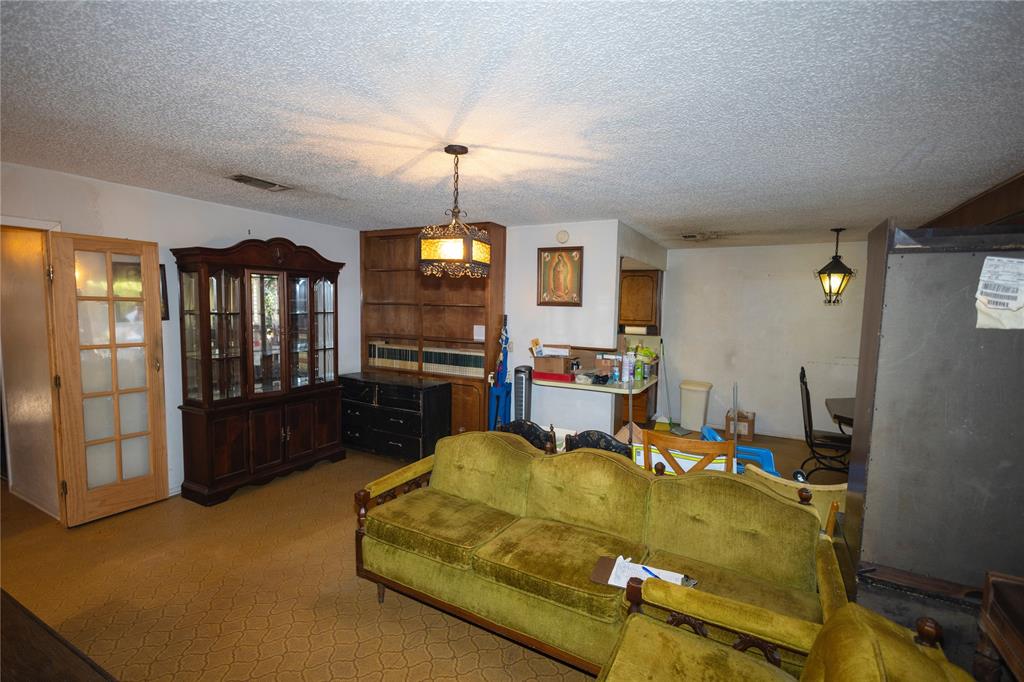 809 Lomo Street Fort Worth, TX 76110 - Photo 11 of 31 a living room with furniture pool table and a chandelier