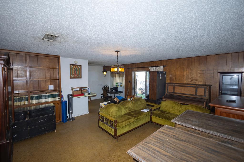 809 Lomo Street Fort Worth, TX 76110 - Photo 13 of 31 a living room with furniture fireplace and a table