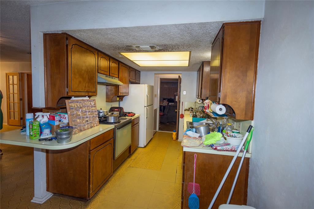809 Lomo Street Fort Worth, TX 76110 - Photo 15 of 31 a kitchen with stove and refrigerator