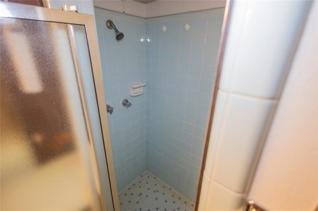 809 Lomo Street Fort Worth, TX 76110 - Photo 18 of 31 a bathroom with a shower and a sink