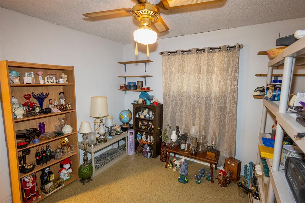 809 Lomo Street Fort Worth, TX 76110 - Photo 21 of 31 a view of a room with lots of shelves
