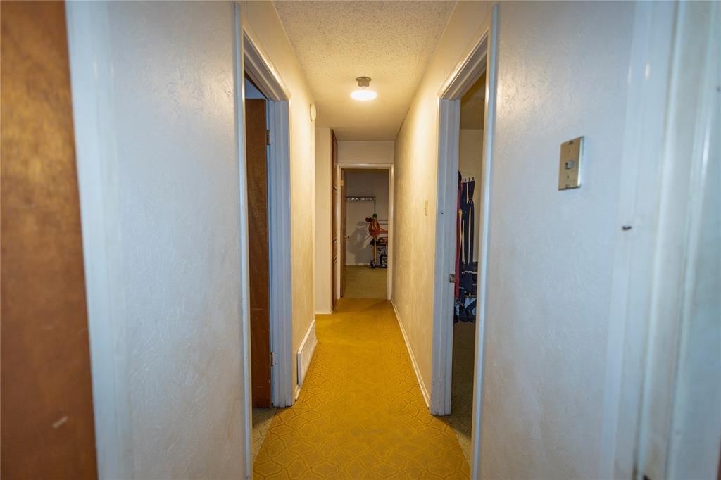 809 Lomo Street Fort Worth, TX 76110 - Photo 22 of 31 a view of a hallway with wooden floor