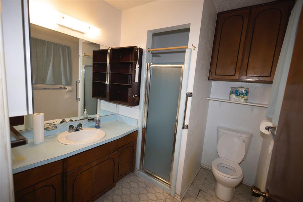 809 Lomo Street Fort Worth, TX 76110 - Photo 26 of 31 a bathroom with a sink toilet and shower