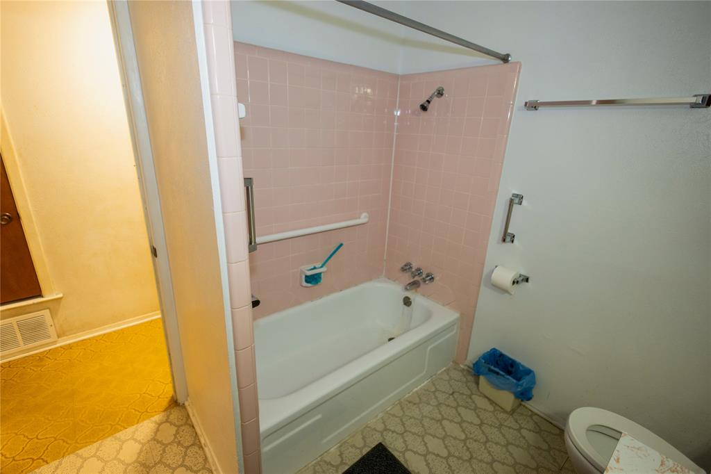 809 Lomo Street Fort Worth, TX 76110 - Photo 29 of 31 a bathroom with a tub and a shower