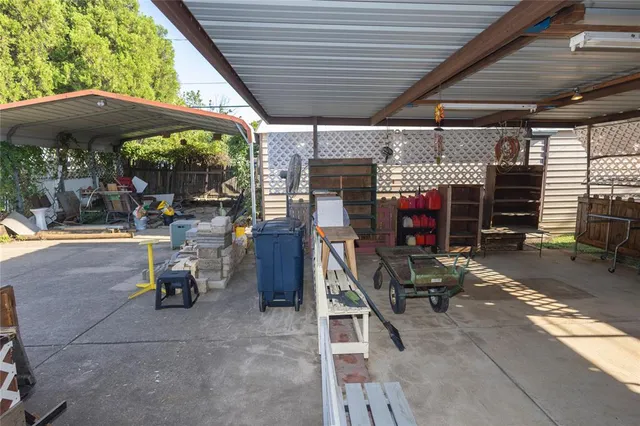 a view of the patio with table and chairs under an umbrella