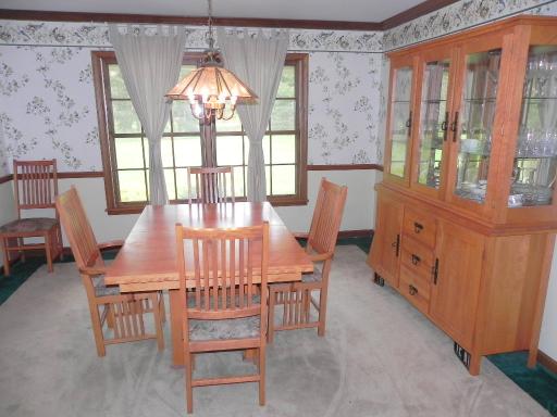 5N485 Oak Road St. Charles, IL 60175 - Photo 5 of 16 a view of a dining room with furniture a chandelier and a large window