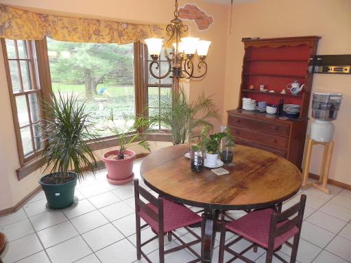 5N485 Oak Road St. Charles, IL 60175 - Photo 10 of 16 a view of a dining room with furniture a potted plant and a chandelier