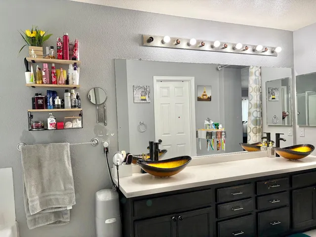a bathroom with a sink double vanity and a mirror