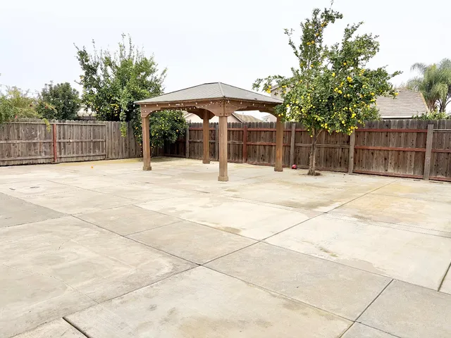 a swimming pool with an outdoor space and seating