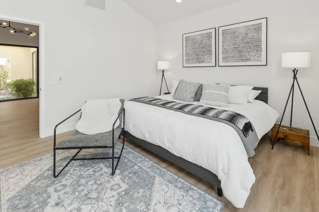 a bedroom with a bed and a desk