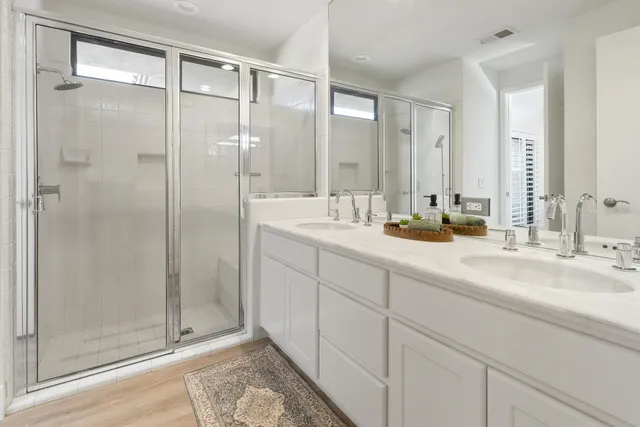 a bathroom with a shower sink and mirror