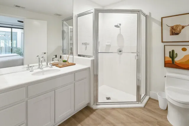 a bathroom with a sink a toilet and shower