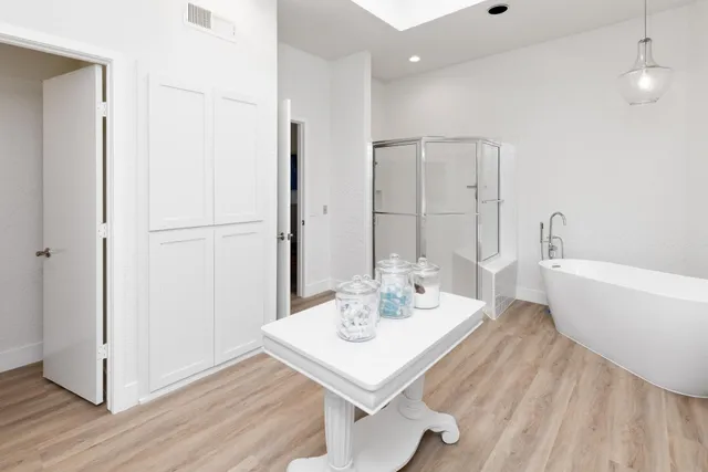 a view of a kitchen area with furniture and wooden floor