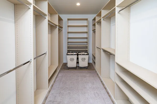 a view of walk in closet with empty racks