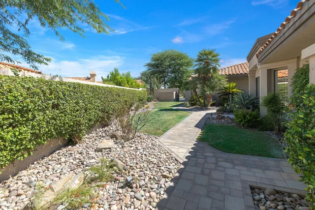 a view of a pathway with a garden