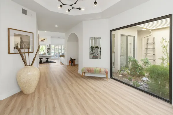 a living room with furniture and a wooden floor
