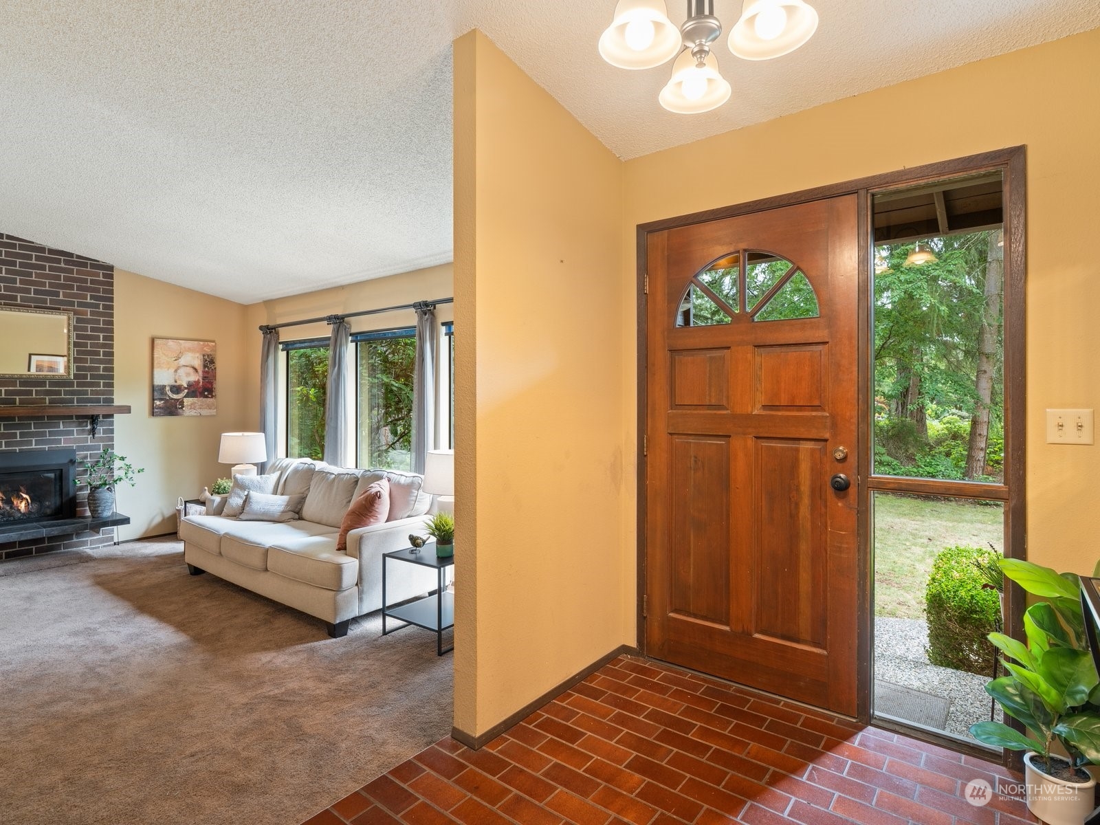 22211 49th Avenue Southeast Bothell, WA 98021 - Photo 3 of 37 a living room with furniture a fireplace and a large window