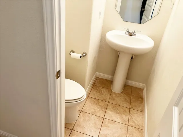 a bathroom with a sink toilet and a mirror